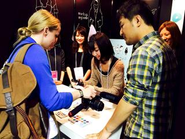 デザインの祭典「TOKYO DESIGNERS WEEK 2013」に自社で作成したスマートフォンアプリを出展時の様子。この時は昭和女子大のインターン生にブース対応を手伝ってもらいました。2014年も出展。