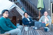 自社ビル屋上の空きスペースを活用した都市型グランピング施設「the EXPerience Rooftop Uehonmachi」で寛ぐ、COOのKenさん, 天川社長, 経理部長の坂下さん