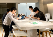 リモートワークとオフィスの壁、チーム、職種、役職の壁を超えフラットに助け合いながら課題解決に向き合っています。